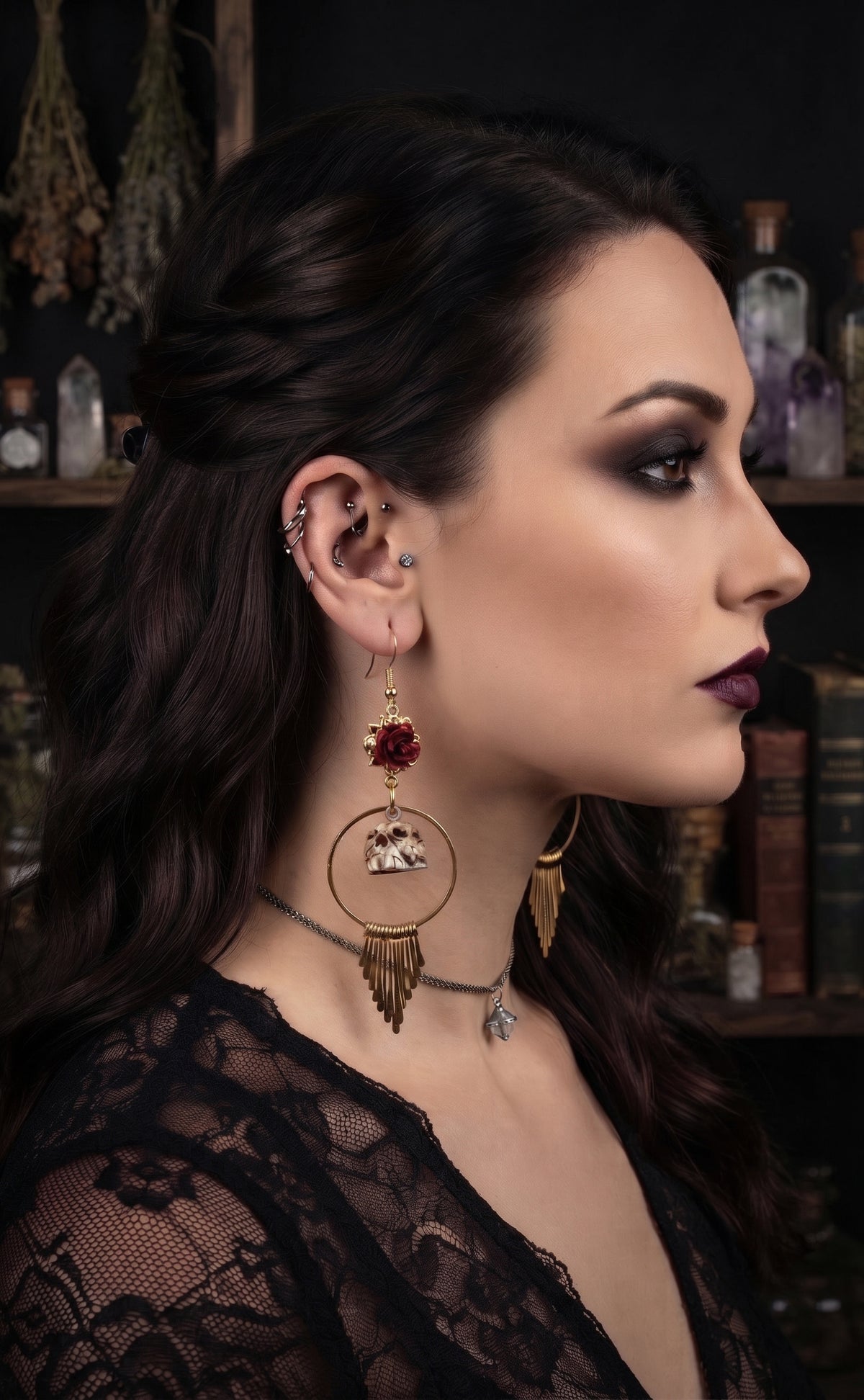 An ai mocked up woman in profile wearing dramatic gothic jewelry, including a large gold-toned hoop earring with a red gemstone and dangling tassel, a matching necklace, and multiple ear piercings, set against a dark, moody background with books and bottles.