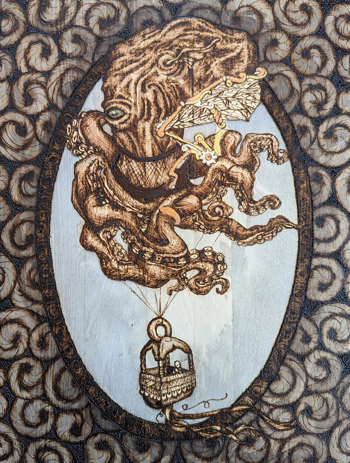 Another view of Cephalapunktopus art print by CamiThunderInk, a steampunk octopus with mechanical wings carrying a passenger in a basket like a hot air balloon, with gold and silver accents