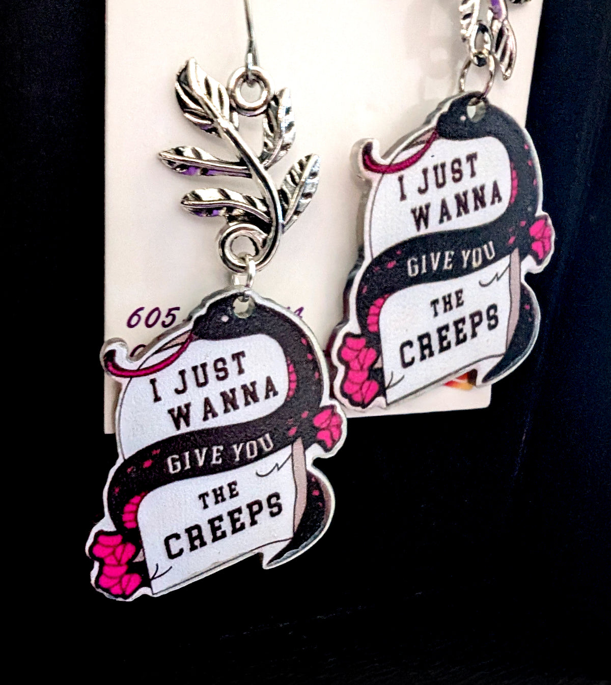Wanna Give You The Creeps Earrings by Circle of Heather, tight crop on the printed snake artwork and silver-tone leaf branch connector, shown on the branded Circle of Heather card.