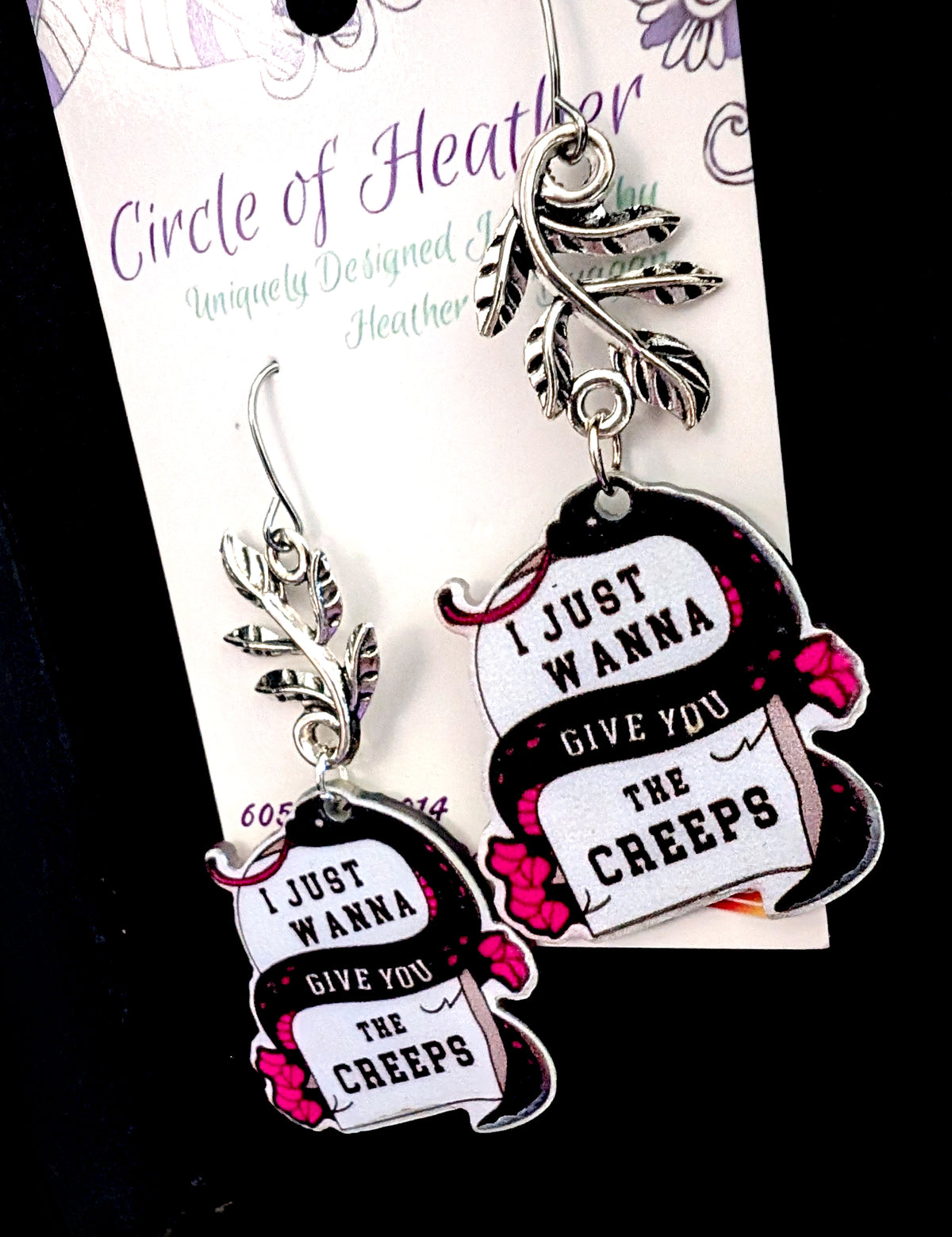 Wanna Give You The Creeps Earrings by Circle of Heather, tight crop on the printed snake artwork and silver-tone leaf branch connector, shown on the branded Circle of Heather card.