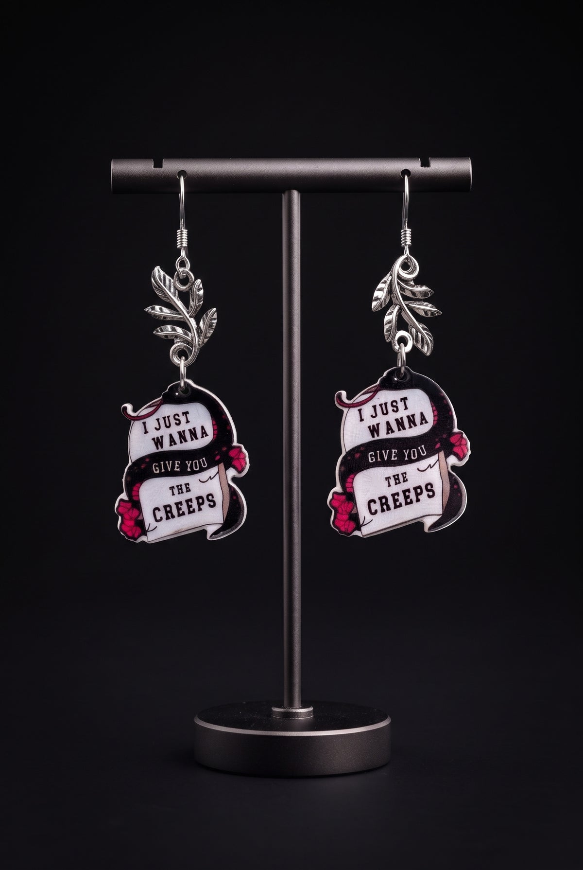 Wanna Give You The Creeps Earrings by Circle of Heather, tight crop on the printed snake artwork and silver-tone leaf branch connector, shown on the branded Circle of Heather card.