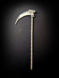 Isolated product shot of the silver scythe hair pick against a pure black background, showing the full length of the ribbed shaft, the skull joint, and the filigree-etched blade.