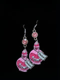 A pair of dangling earrings featuring pink illustrated potion bottles with cartoon faces and the text 'Immortal Elixir' on a black background.