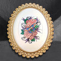 Flutter over Camellias by CamiThunderInk, an original ink and alcohol marker drawing of a colorful moth among camellias and ornamental scrollwork, in a gold scalloped oval frame