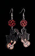 Guitar Ghoul Earrings by Circle of Heather, full view of both mirrored charms showing the skeleton linework and cream hollow-body guitars with leopard print disc tops, on a plain black background.