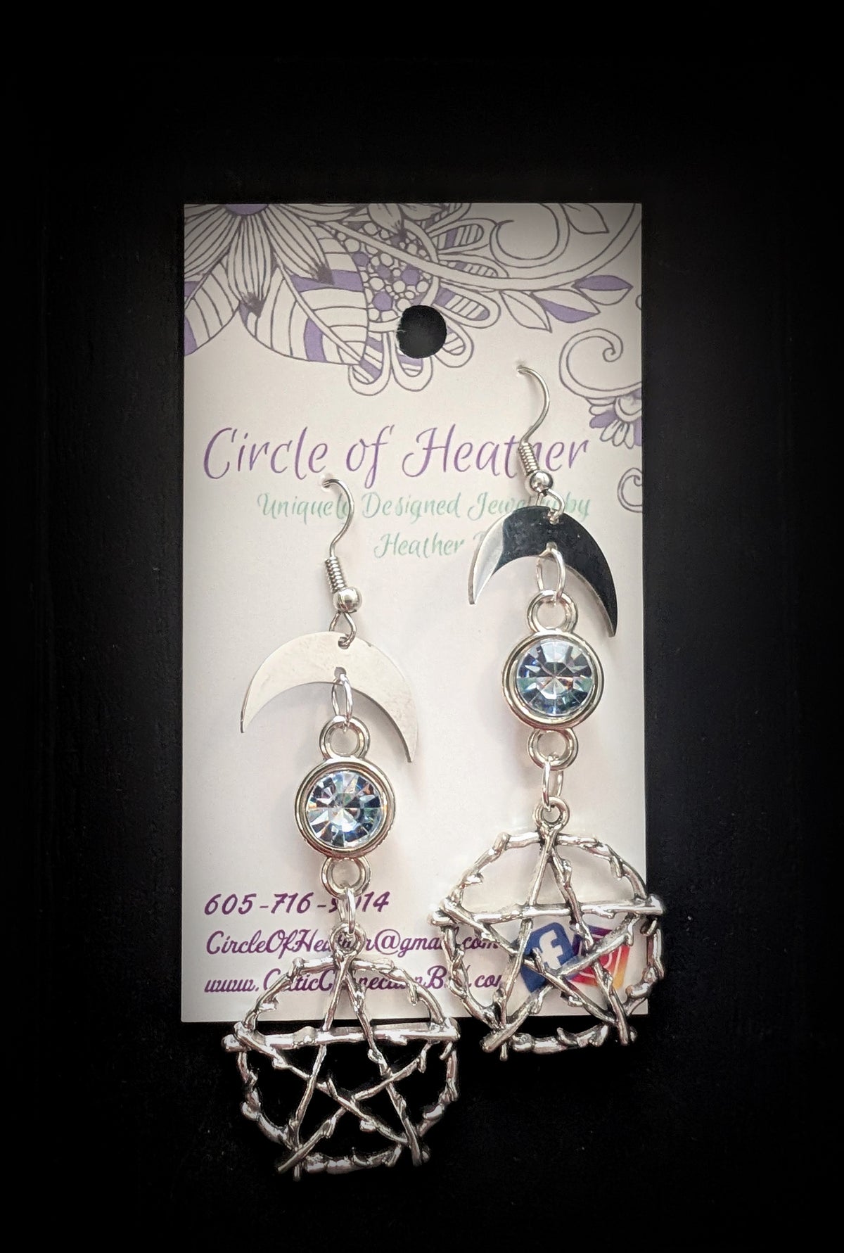 Pentacle Lunar Blue Blush Earrings by Circle of Heather, both earrings shown on the branded Circle of Heather card with silver crescent moons, pale blue stones and twig pentacles.
