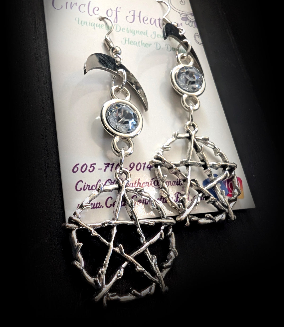 Pentacle Lunar Blue Blush Earrings by Circle of Heather, angled close-up showing the bound twig detail on the pentacle and the pale blue stone in its silver bezel, shown on the branded Circle of Heather card.