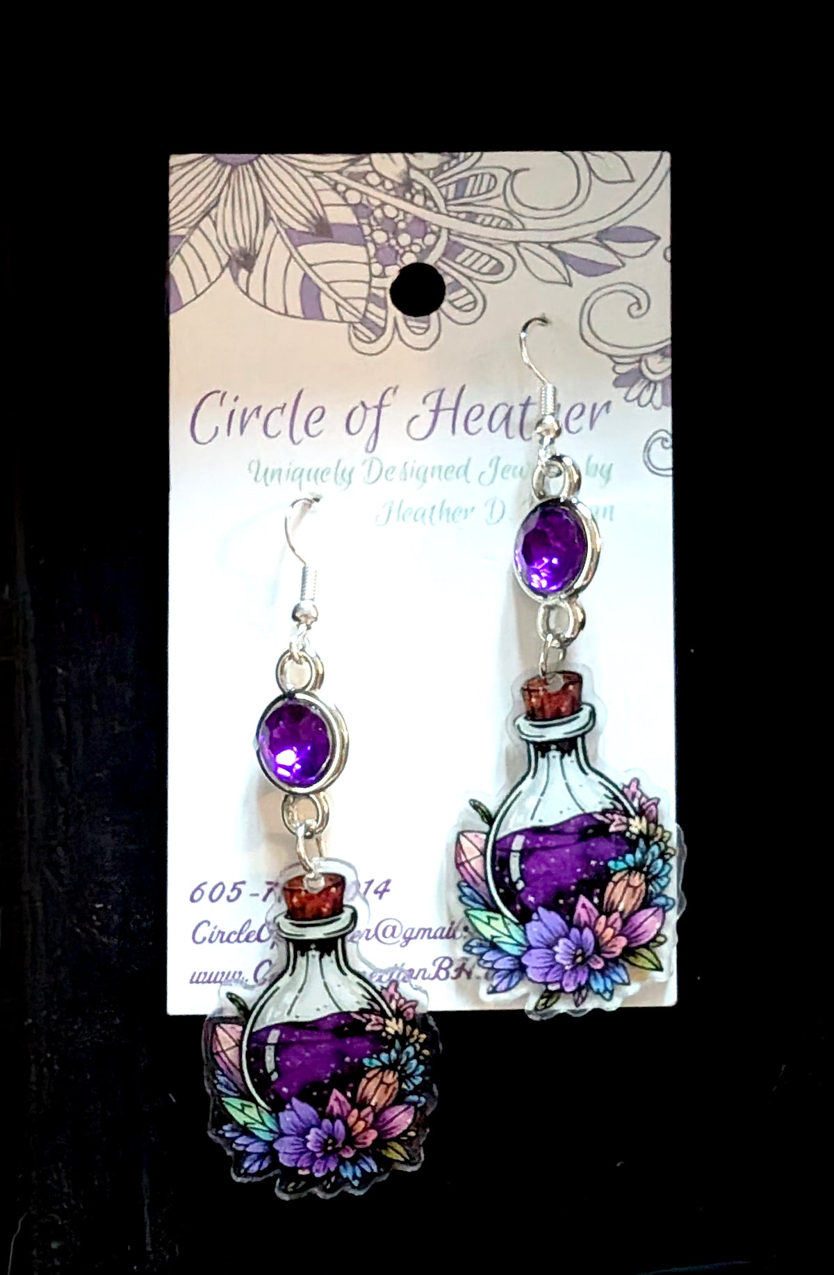 Circle of Heather purple floral potion bottle earrings with amethyst rhinestone accents on jewelry display card