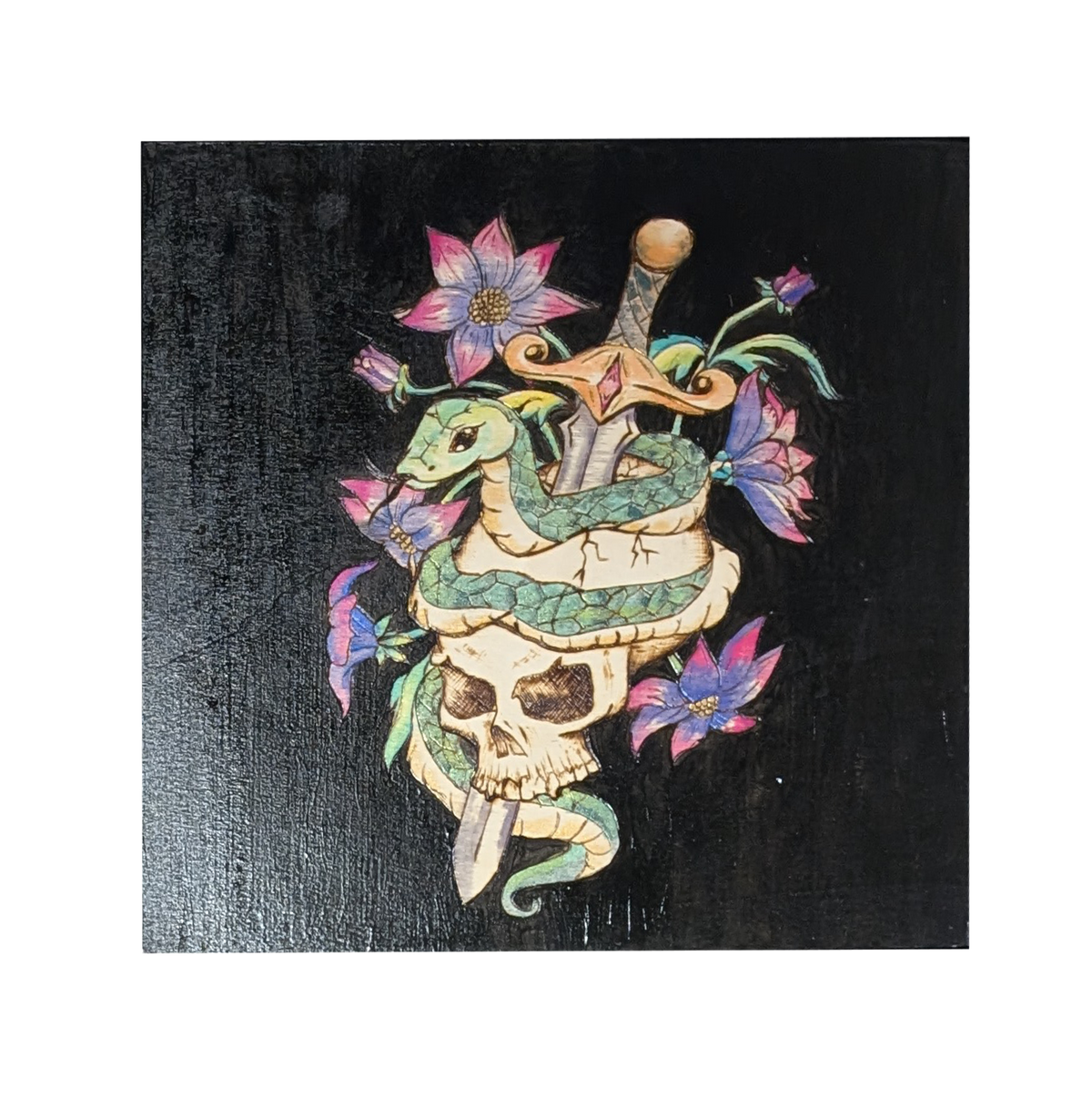 Serenum Serpentis by CamiThunderInk, an original pyrography, watercolor, and acrylic painting on wood showing an emerald green serpent coiled around a skull pierced by a dagger, with pink and purple flowers on a black background