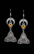 Trinity Lunar Glow Earrings by Circle of Heather, full view of both earrings showing the crescent moon, faceted amber stone and trinity knot charm with pentacle, sun and moon cutwork, on a plain black background.