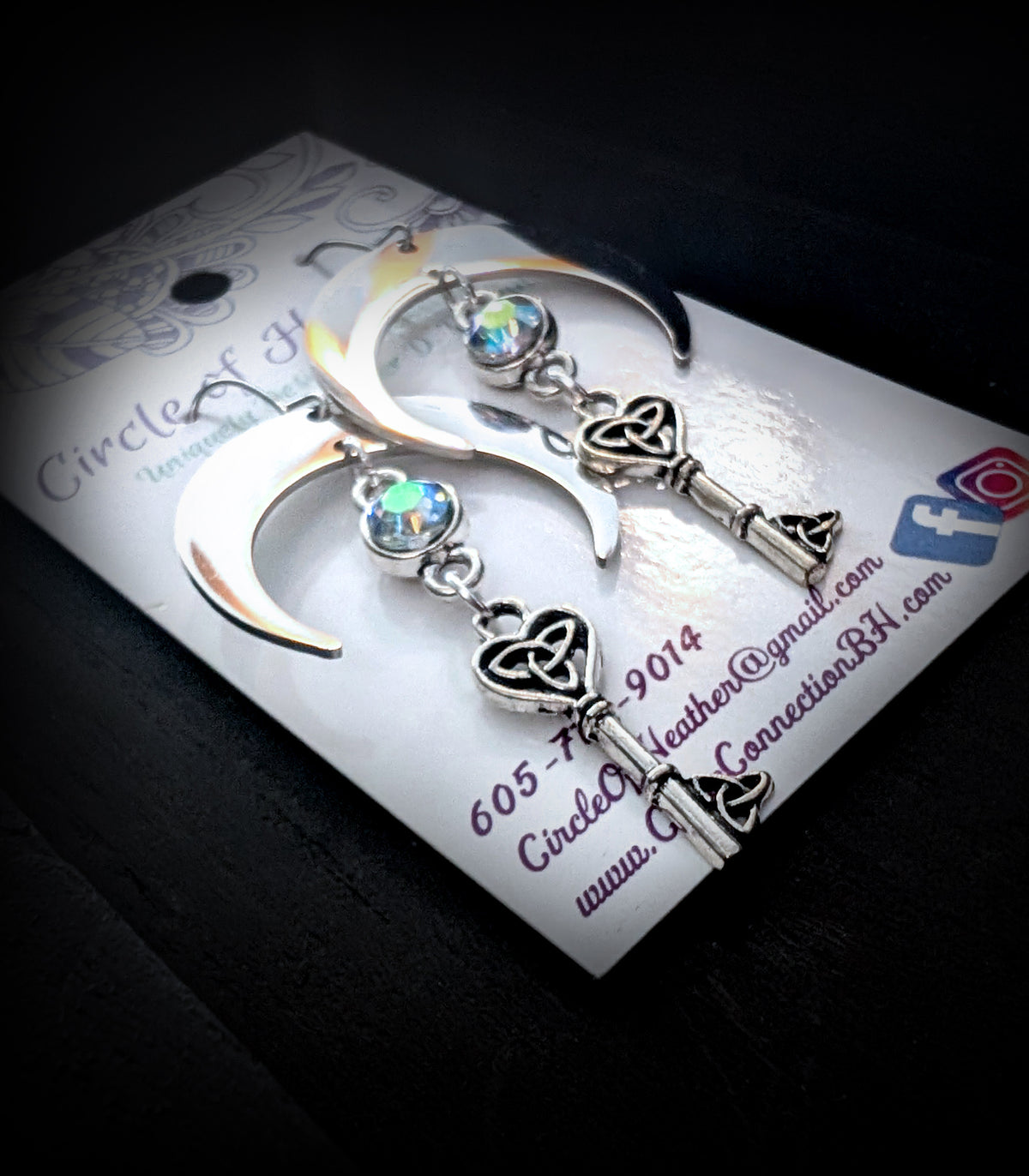 Unlock the Moon Earrings by Circle of Heather, angled close-up showing the trinity knot in the key bow and the knotwork teeth at the base of the key, shown on the branded Circle of Heather card.