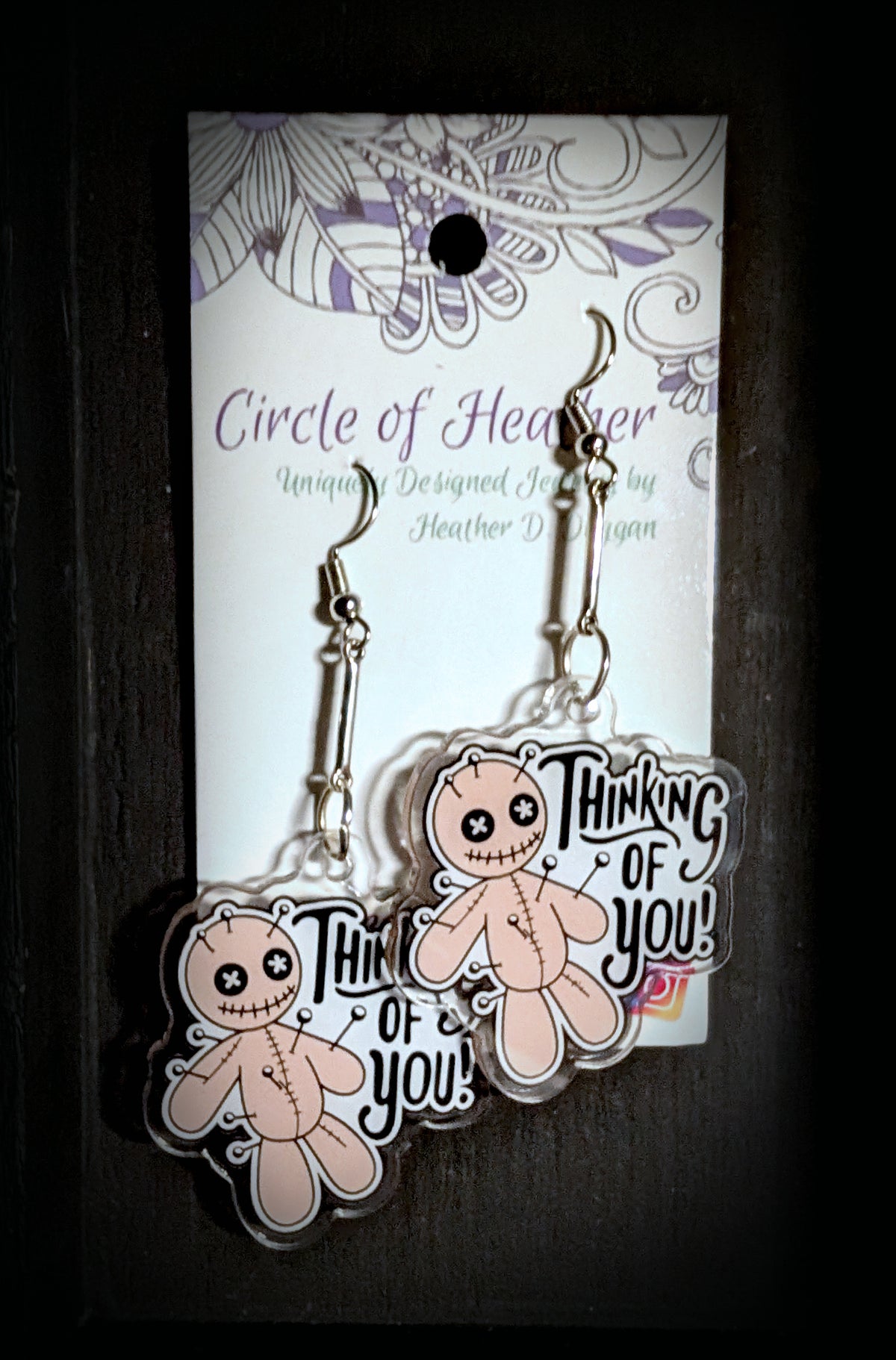 Voodoo Doll Thinking of You Earrings by Circle of Heather, both earrings shown on the branded Circle of Heather card with silver-tone bar connectors and printed voodoo doll charms.