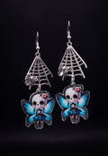 Webbed Skull Fairy Earrings by Circle of Heather, silver-tone spider web charms and printed skull fairy charms with pink flower crowns, shown on the branded Circle of Heather card.