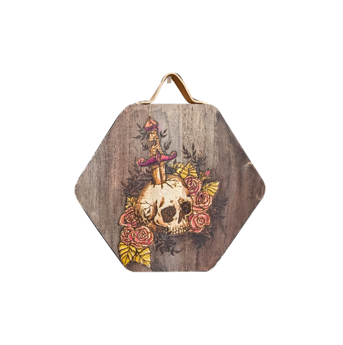 Another view of Arthur's Rosy Relic by CamiThunderInk, an original pyrography and watercolor piece on solid wood showing a skull pierced by a dagger and surrounded by bright pink roses