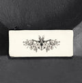 Floral Bat canvas pencil case by CamiThunderInk, a cream canvas zip pouch printed in black ink with a long eared bat over open blooms, with a black zipper