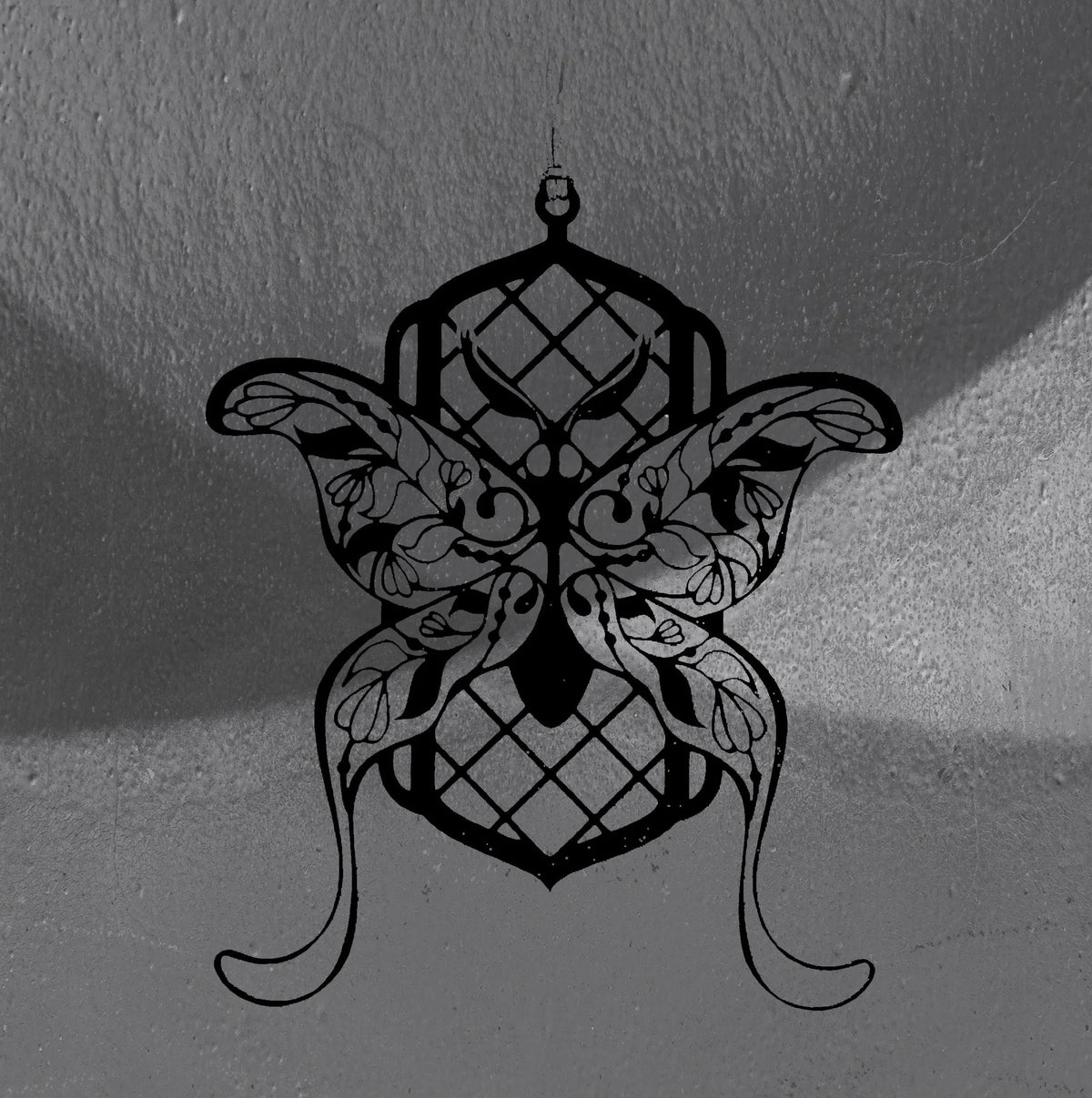 Floral Moth wall hanger by CamiThunderInk, a matte black 3D printed moth with lattice body panels, floral wings, and curled feet