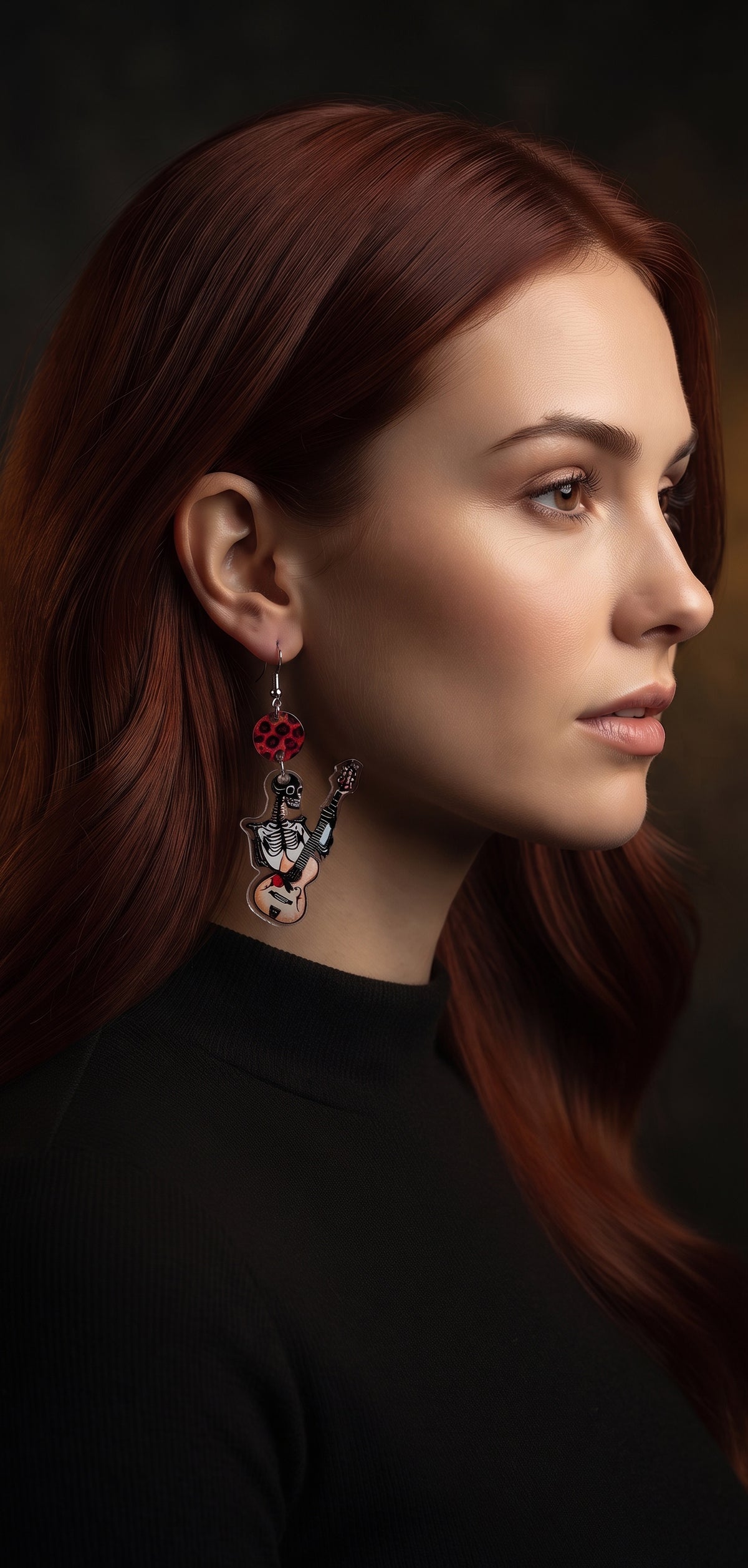 Guitar Ghoul Earrings by Circle of Heather worn by a model with long auburn hair and a black mock neck top, red leopard print disc above a printed acrylic charm of a skeleton playing a guitar.