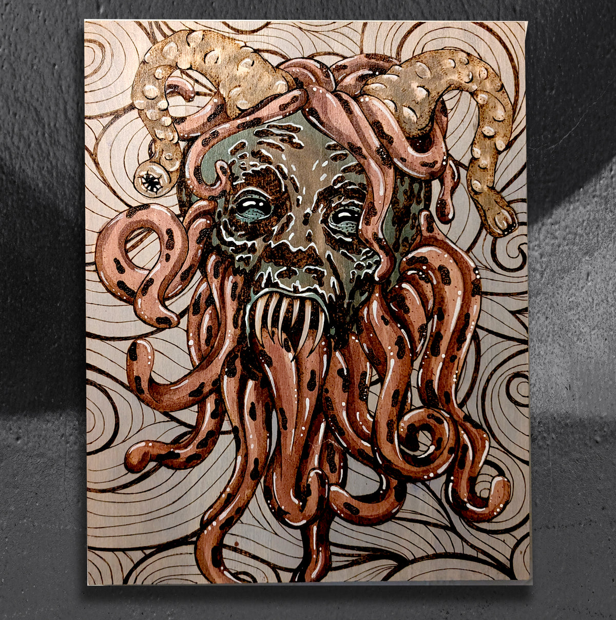 Kramptopus by CamiThunderInk, an original pyrography, watercolor, and stain painting on a solid wood slab of Krampus as a deep sea creature with tentacle horns and long tongues around the face
