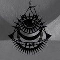 Punk Evil Eye wall hanger by CamiThunderInk, a matte black 3D printed eye with a spiked lash crown, a toothed lower lid, and wing points on each side