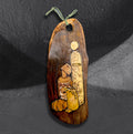 Punkins and Poisons by CamiThunderInk, an original pyrography and stain piece on a live edge olive wood board showing a dripping candle, a poison bottle, a potion, and a small pumpkin, hanging from a sage green cord