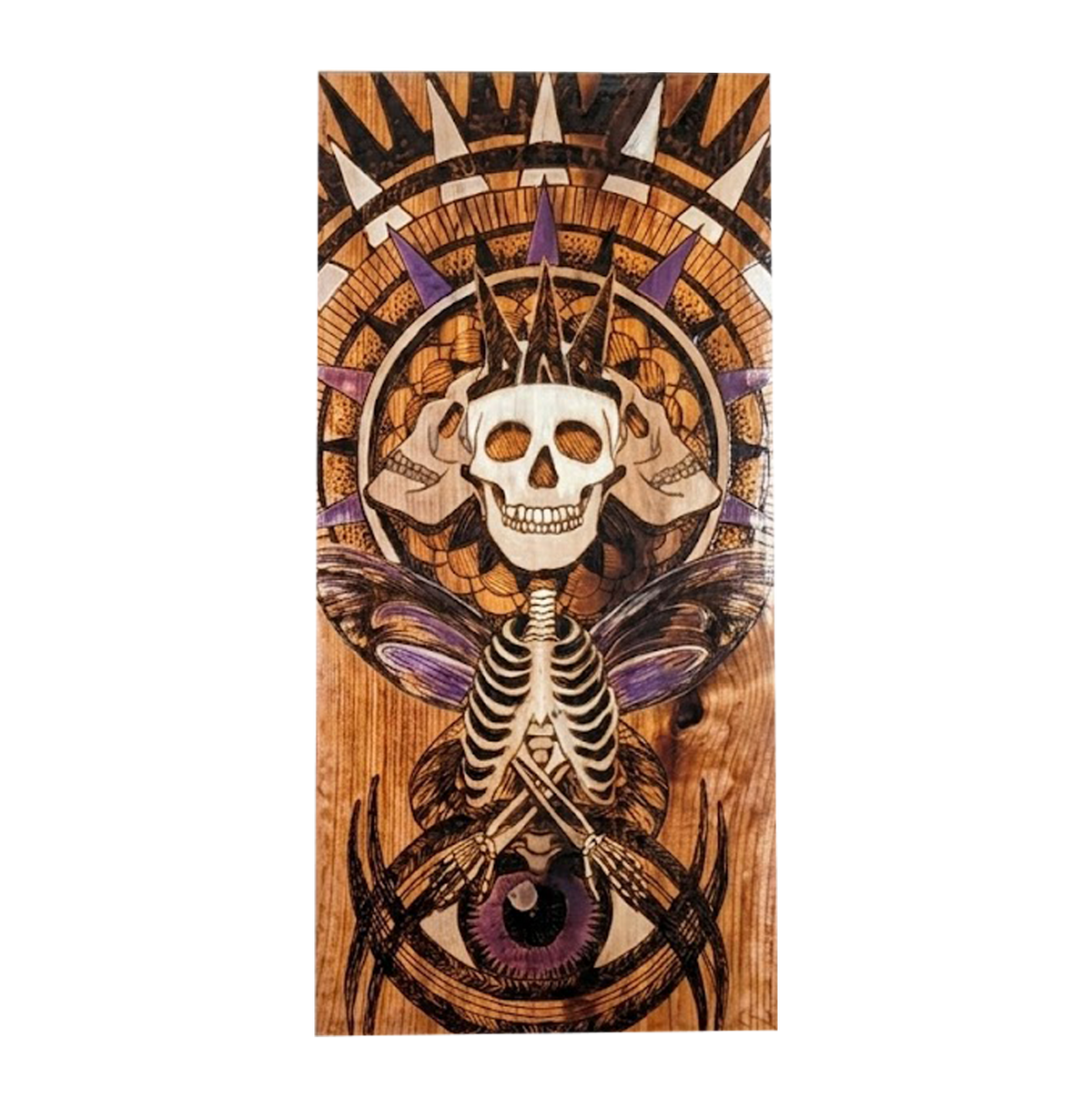Another view of Crowned Triple Skeleton by CamiThunderInk, an early pyrography, watercolor, and resin piece on scrap wood showing a crowned triple skull in a spiked halo, a moth with a ribcage body, and an eye below, in purple and warm wood tones