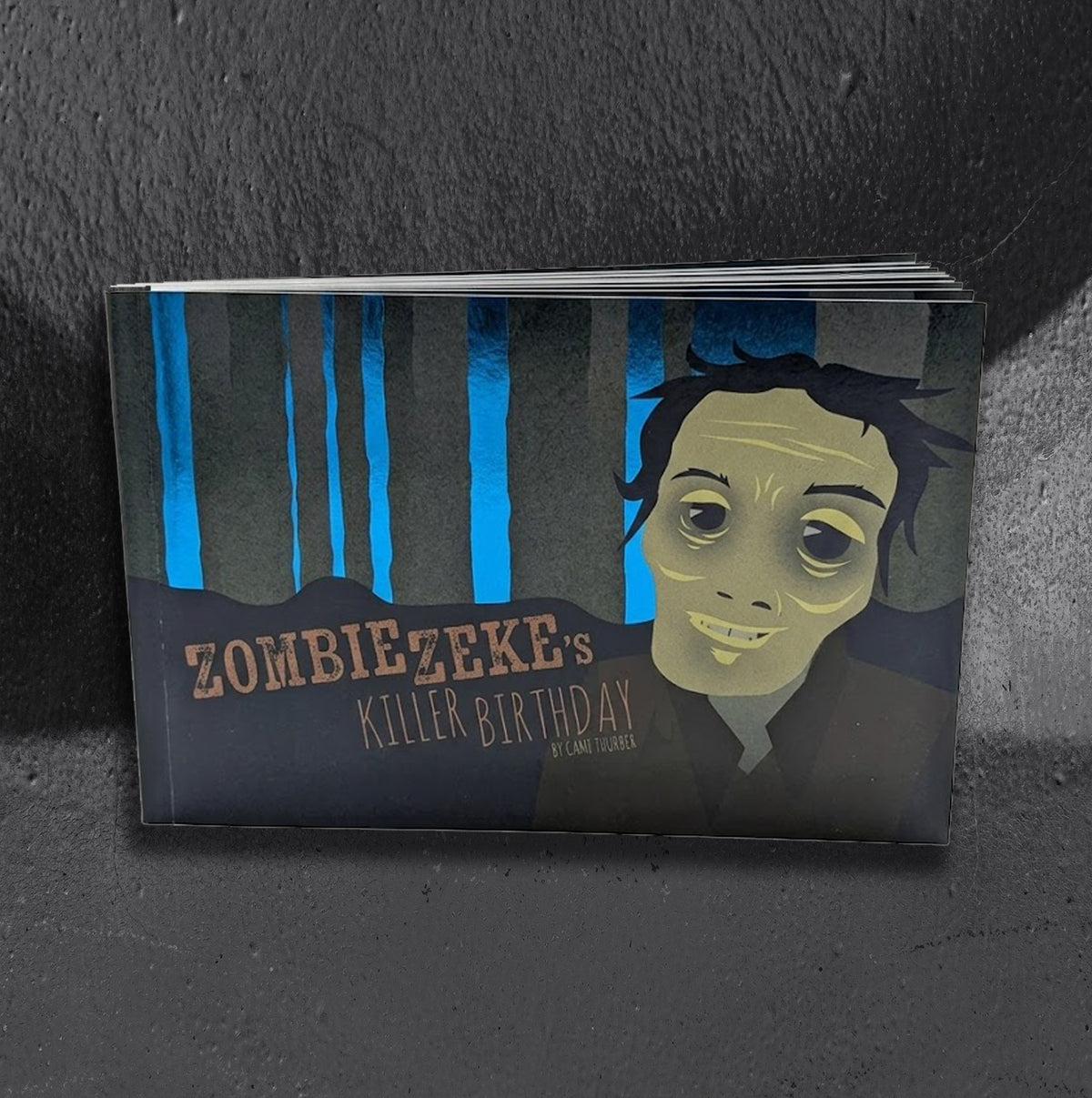 Zombie Zeke's Killer Birthday, an illustrated children's picture book written and illustrated by Cami Thunder about a little zombie planning a birthday party in his grave
